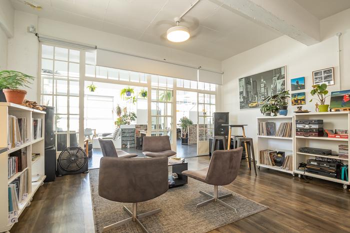 Kitchen and lounge area with vinyl record shelves at Cape Town Office