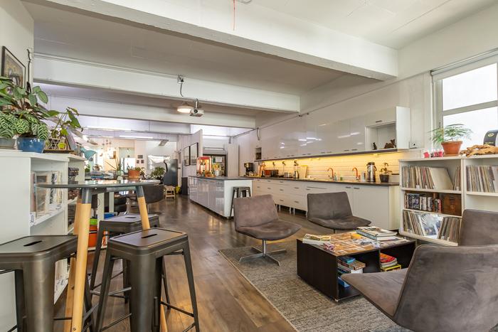 Lounge and shared work table with bike storage at Cape Town Office