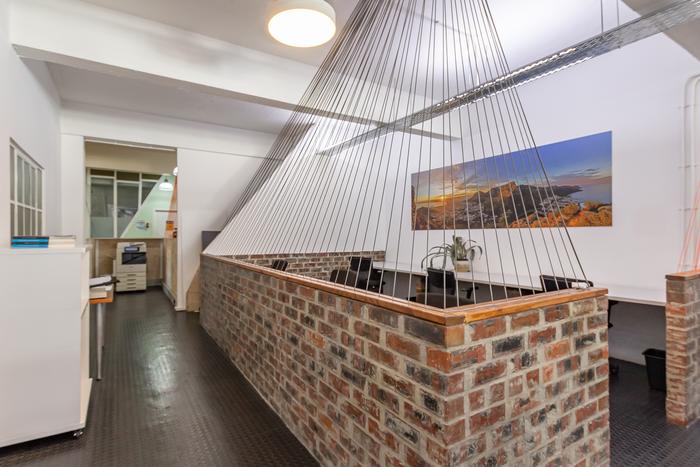 Reception desk with Cape Town artwork at Cape Town Office