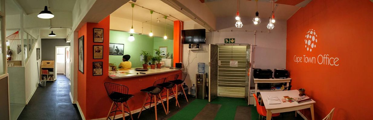 The Cape Town Office kitchen and orange brand wall